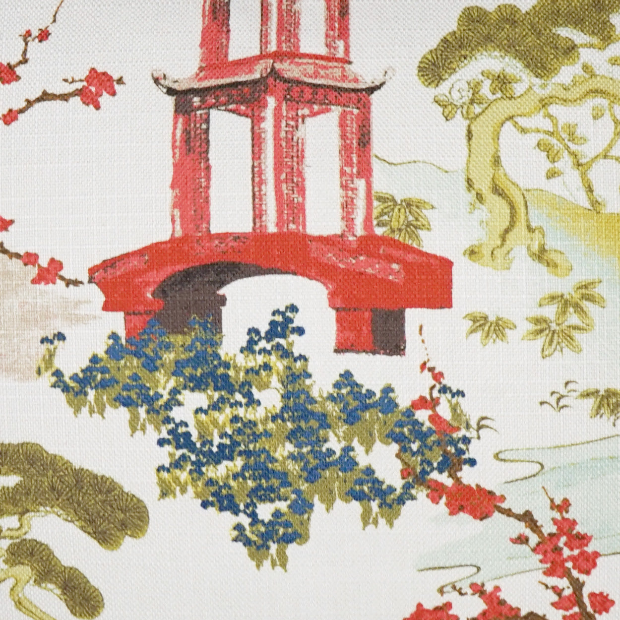 Chinoiserie pillow pattern featuring a red pagoda with blue blossoms and olive-green trees.