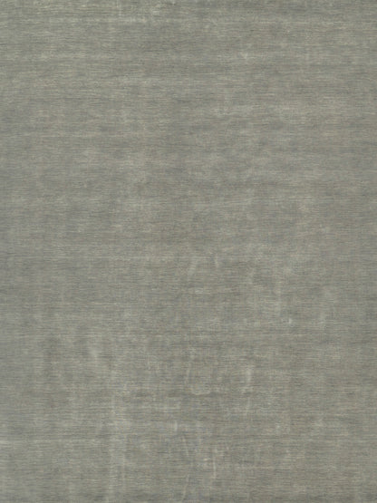 Gray textured rug with a soft brushed surface and a faint circular medallion pattern.