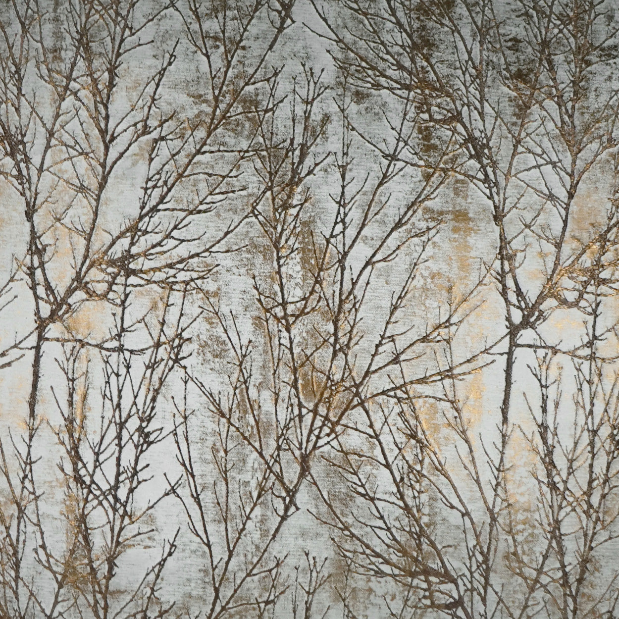 Fabric featuring bare tree branches pattern in gray, beige and tan tones.