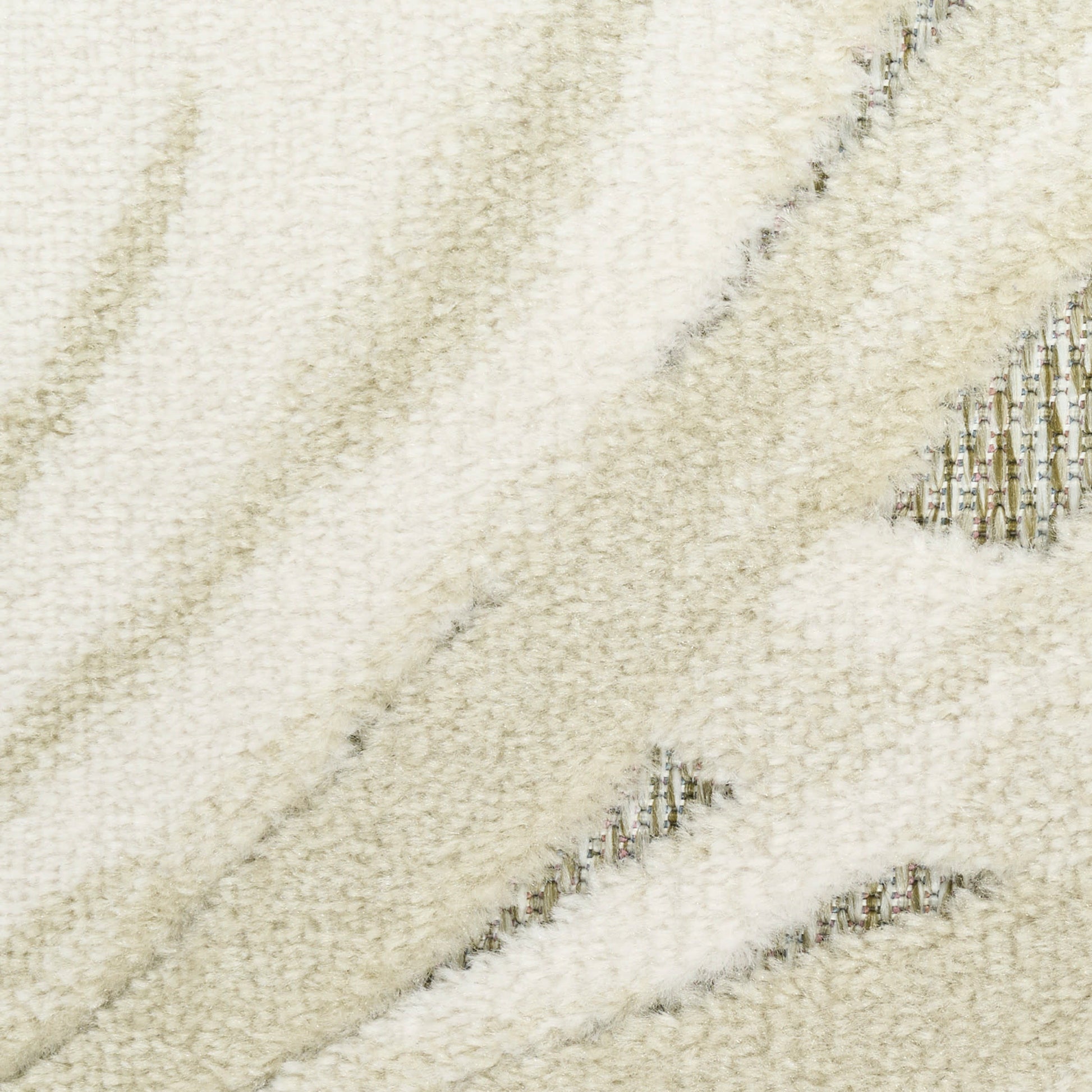 Cream shag rug close-up with plush ivory pile and subtle diagonal beige stripes.