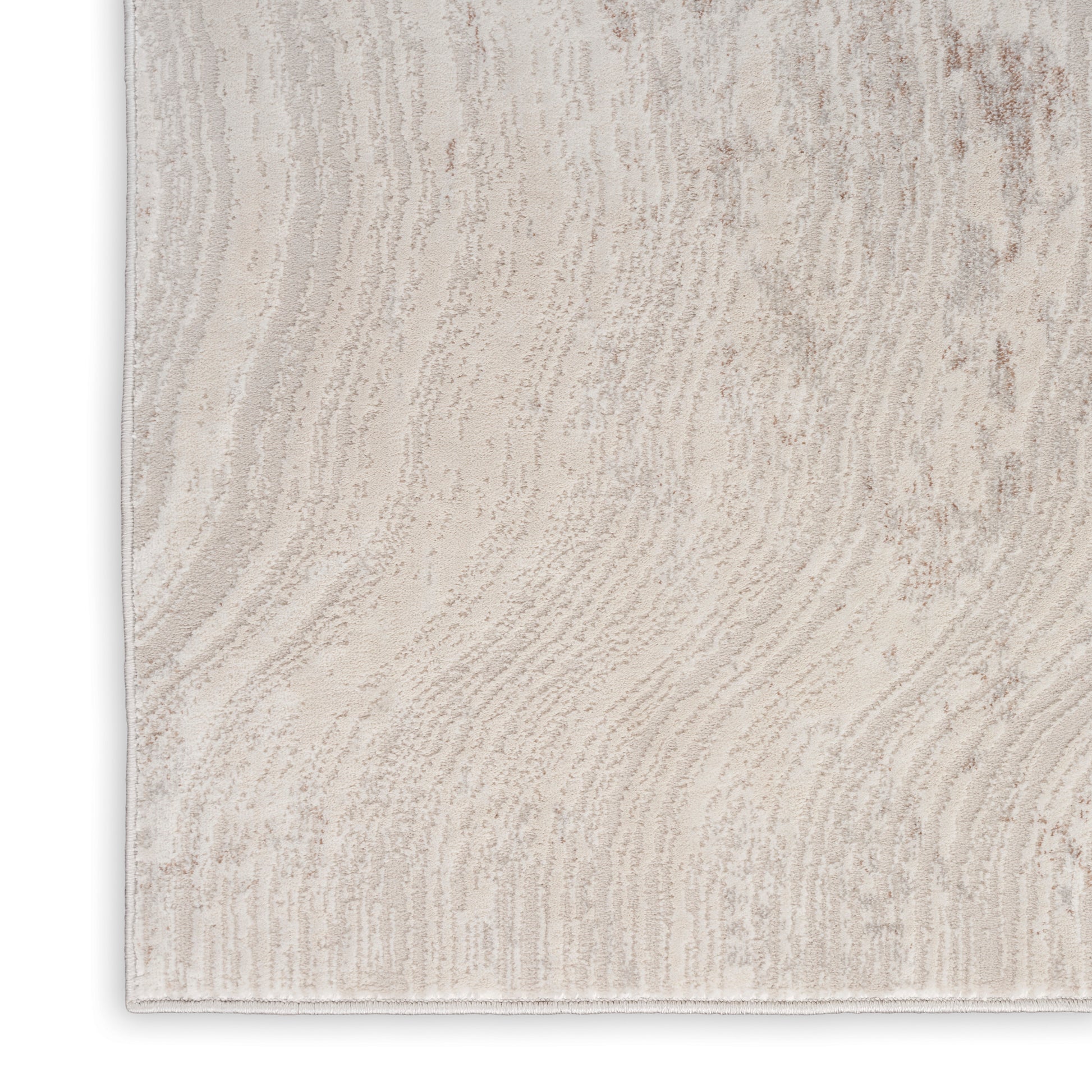 Light beige textured area rug with subtle wavy pattern; rectangular, cozy modern style.