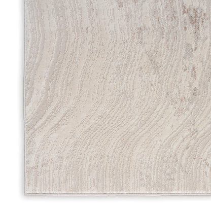 Light beige textured area rug with subtle wavy pattern; rectangular, cozy modern style.