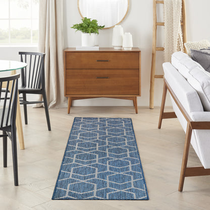 Blue and white hexagon-patterned woven runner rug, narrow and long for a modern living room.