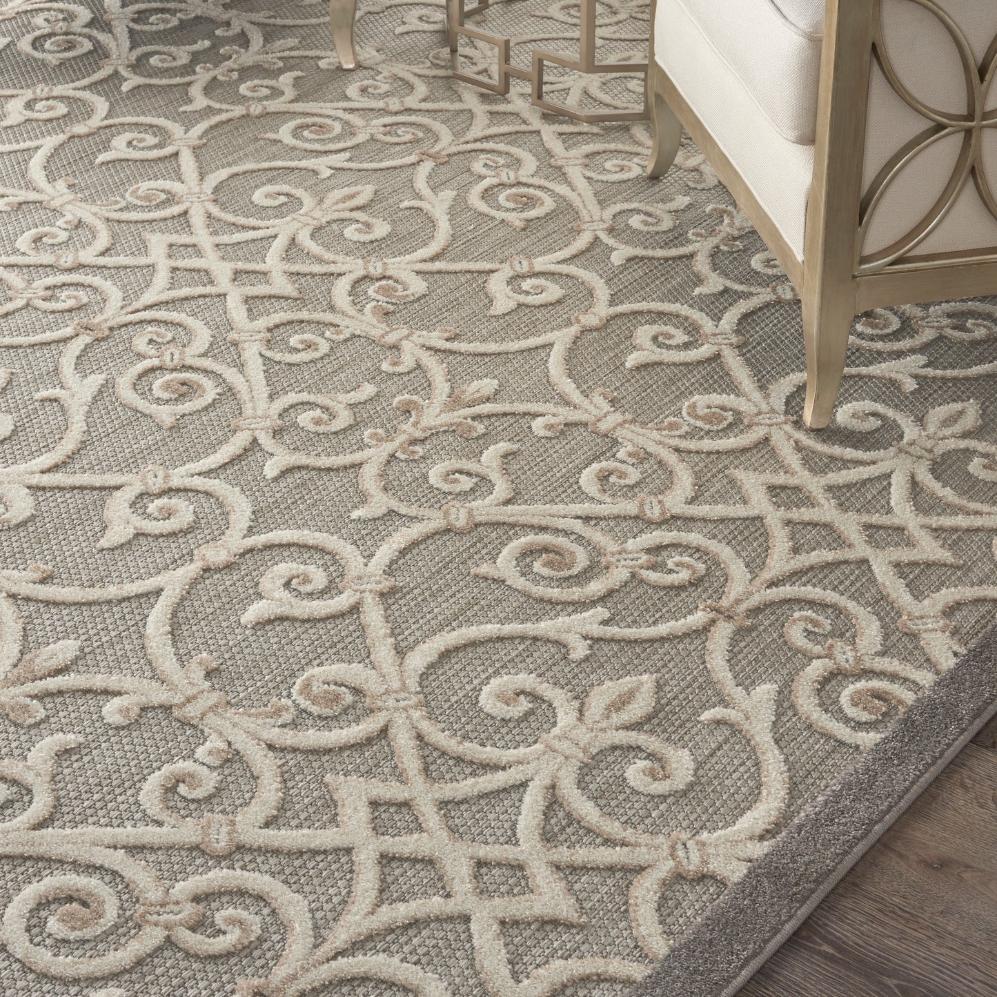Gray area rug with cream scrolling damask pattern; plush pile, elegant living room decor.