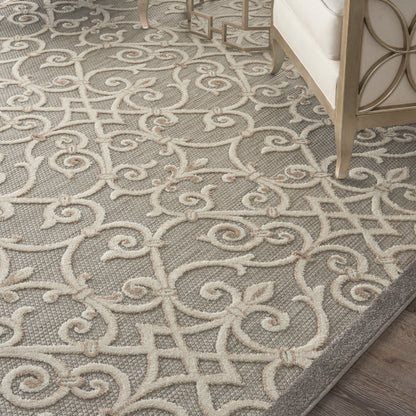 Gray area rug with cream scrolling damask pattern; plush pile, elegant living room decor.