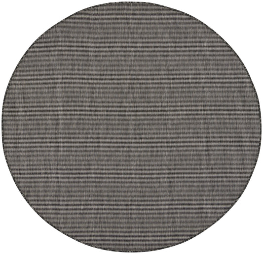 Round woven rug in gray-beige tones with a tight grid texture, modern minimalist style.