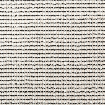 Close-up of cream woven fabric with fine black stripes and textured surface.