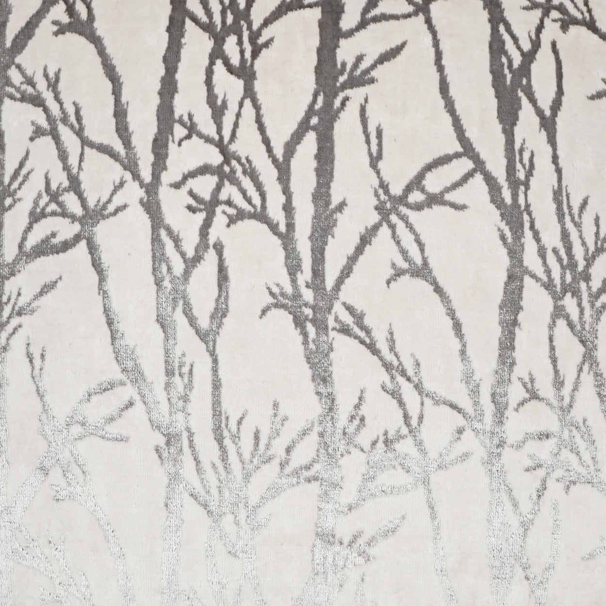 Cream fabric with gray bare-tree forest pattern; nature-inspired upholstery or drapery textile.