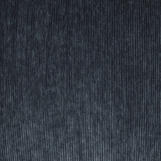Dark indigo corduroy fabric close-up with vertical wales, soft textured textile for jackets or upholstery.