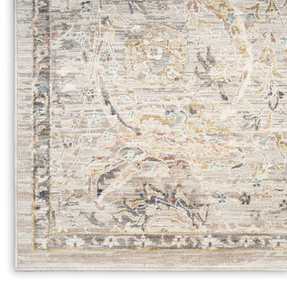 Cream-toned oriental rug featuring muted blue, gold and grey floral motifs and a light beige border.