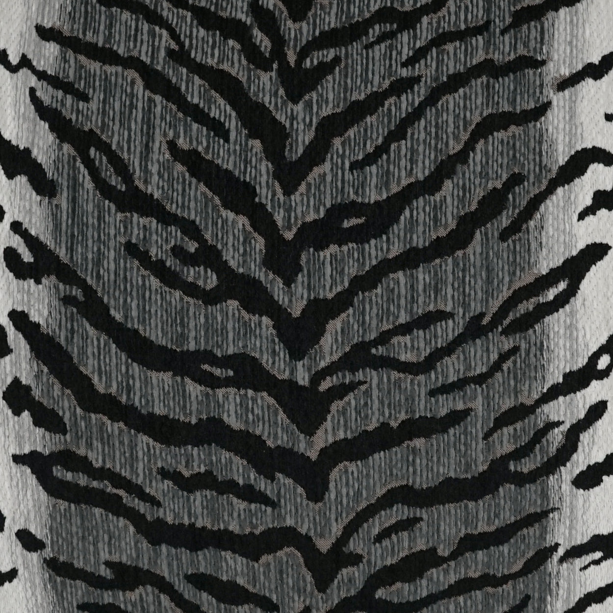 Grey fabric with bold black zebra stripe pattern; soft, textured knit suitable for clothing or upholstery.