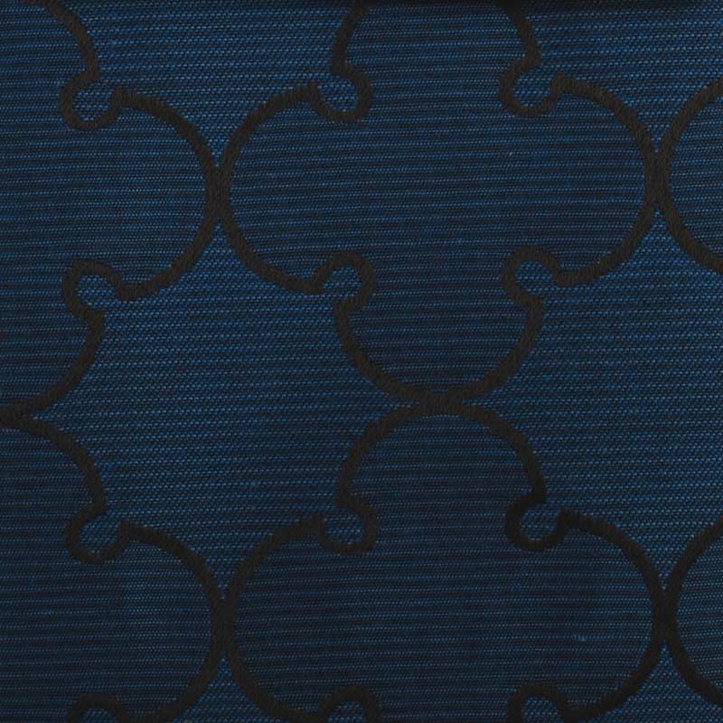 Dark cobalt blue fabric with a black interlocking curved quatrefoil pattern and a subtle diagonal weave; upholstery fabric.