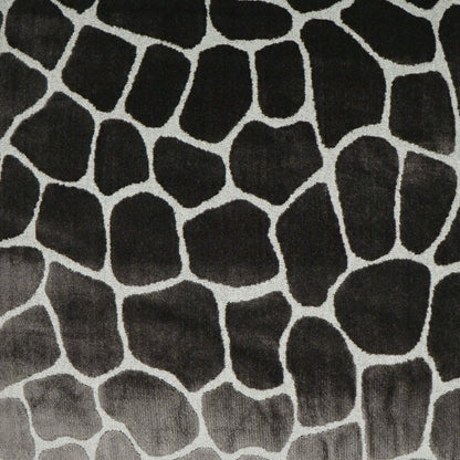 Charcoal-black pillow fabric with an irregular pebble pattern and pale gray outlines resembling stones.