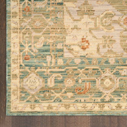 Partial view of a traditional oriental runner rug with teal border, cream field and floral motifs on dark wood floor.
