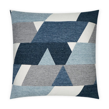 Blue and gray geometric pillow with triangles and trapezoids in varied blue tones.
