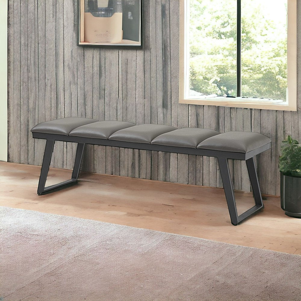 Dark gray faux leather padded bench with angular metal frame, four-seat cushion for modern hall or living area.
