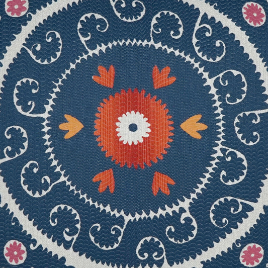 Blue mandala fabric print with concentric rings, orange center flower, white center dot, orange petals, white scrollwork, and pink accents.