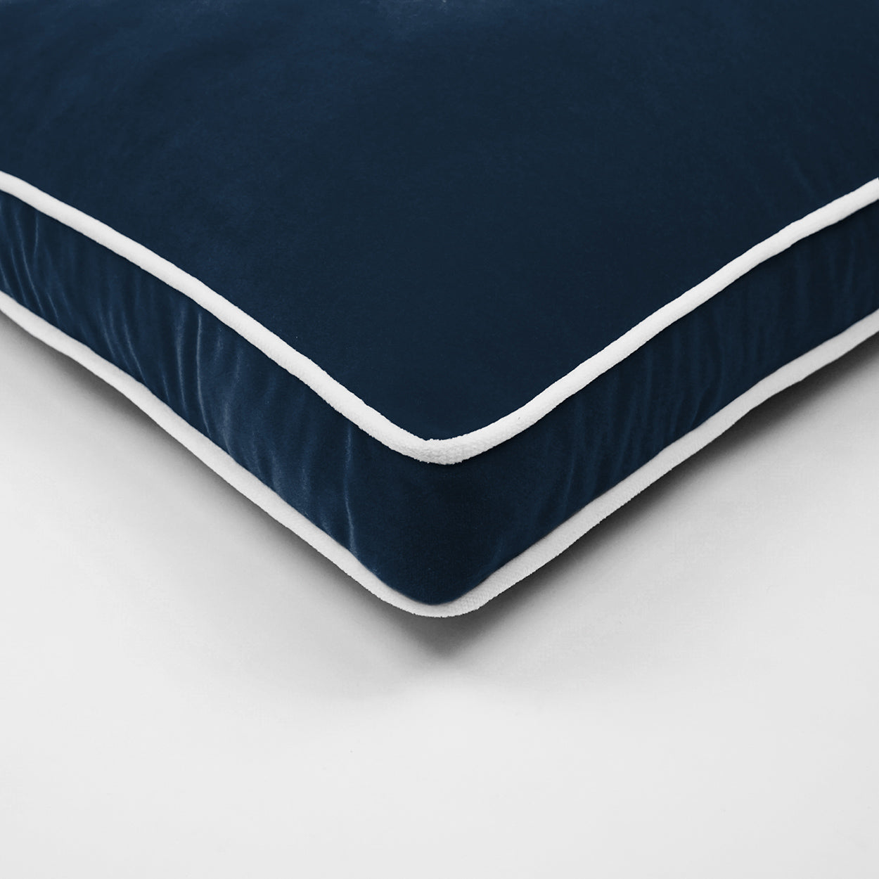 Close-up of navy blue velvet pillow.