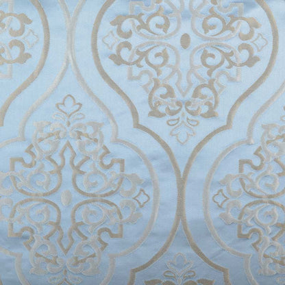 Light blue damask pattern with metallic beige scrollwork and ornate medallions; elegant wallpaper or fabric design.