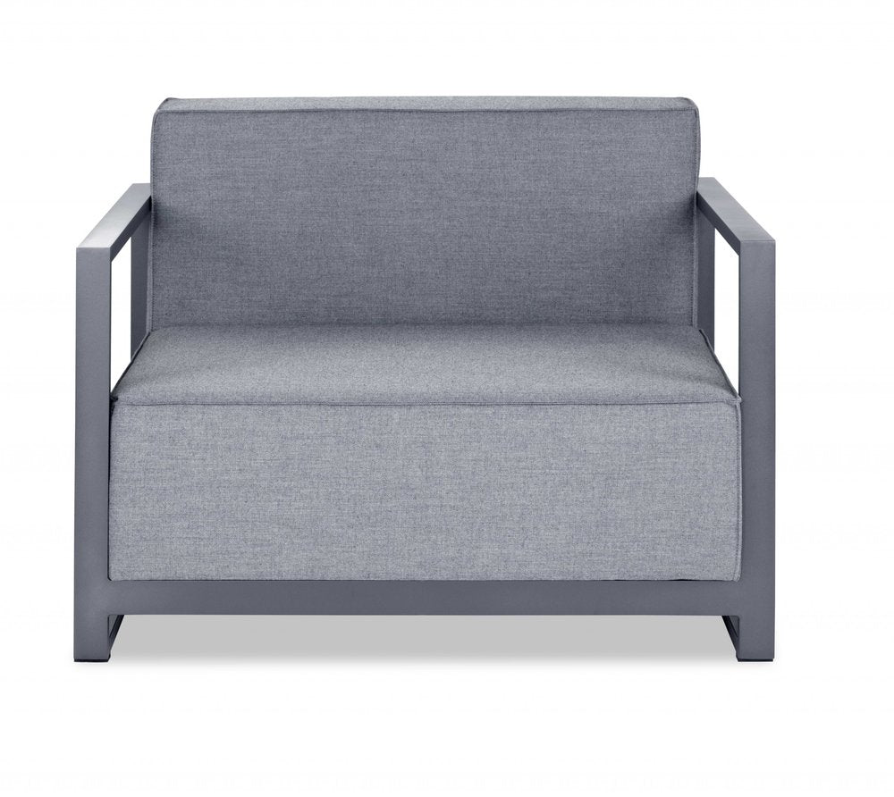 Modern outdoor chair with a slate-gray metal frame, square arms, and light blue-gray cushions.