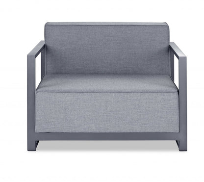 Dark gray metal-framed armchair & pale gray cushions, modern outdoor lounge seating.