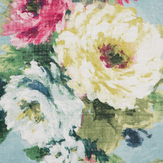 Floral fabric with large yellow and white blooms, pink accents and green leaves on light blue background.
