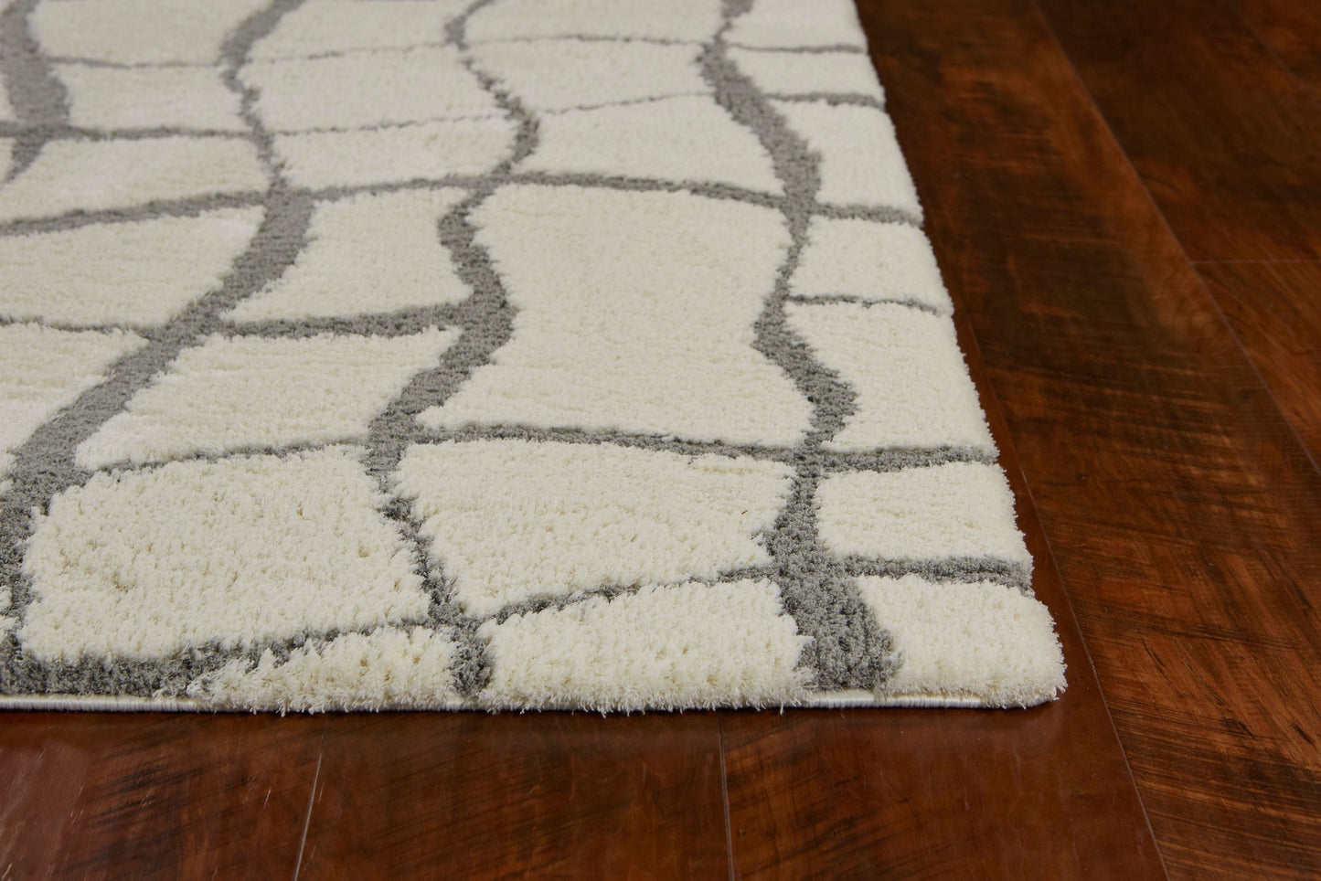 5' X 7' Ivory Machine Woven Abstract Indoor Shag Rug