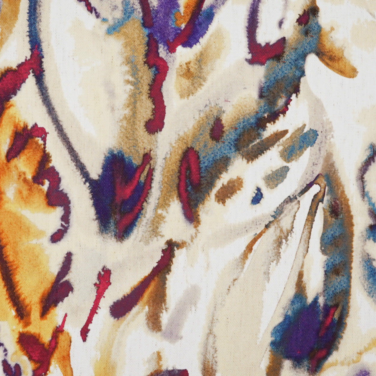 Abstract watercolor fabric print with orange, purple, and blue strokes on cream background.