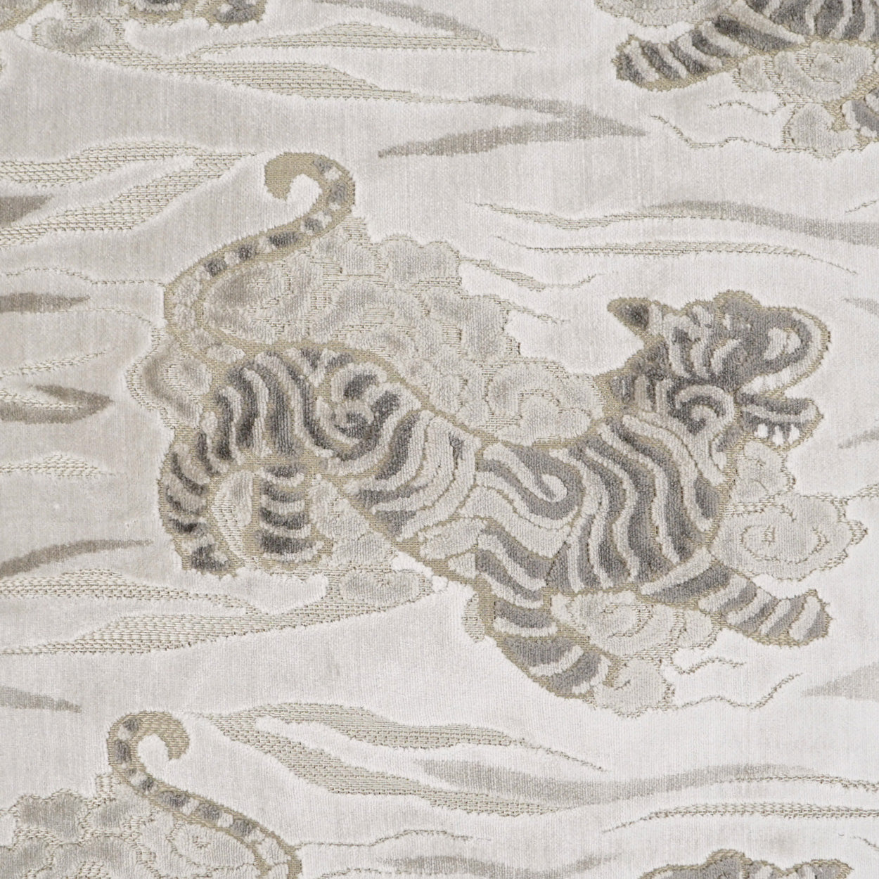 Ivory jacquard fabric with taupe tiger motif woven in a decorative damask-style pattern.