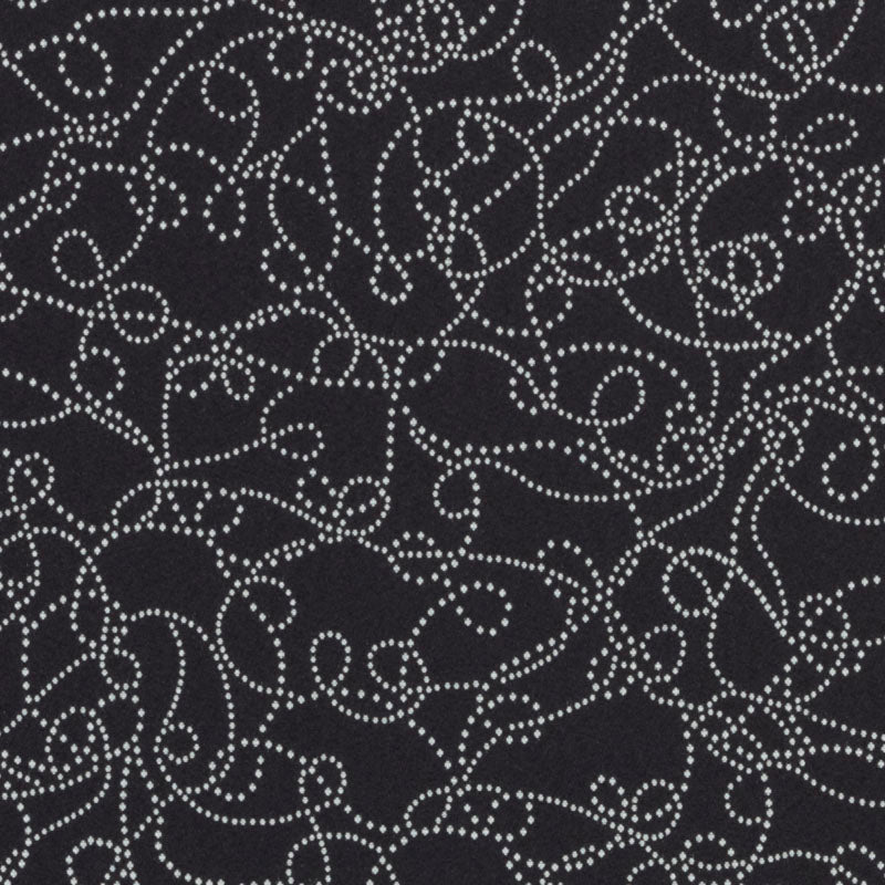 Dark charcoal and white upholstery fabric with a matte finish, featuring a decorative black pattern; minimalist, versatile.