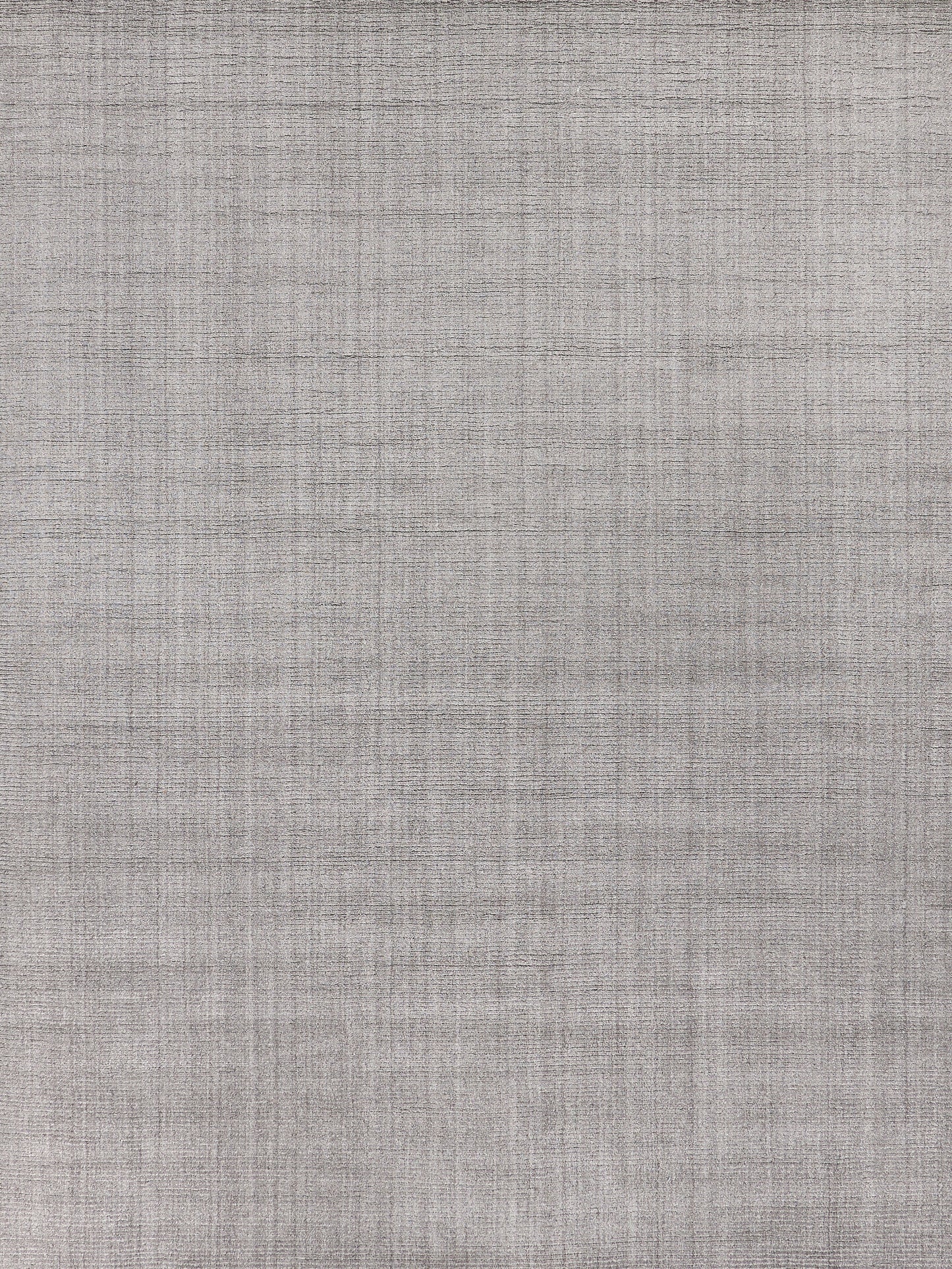 Gray heathered, linen-style woven rug texture with a subtle crosshatch pattern; hand-loomed indoor rug.