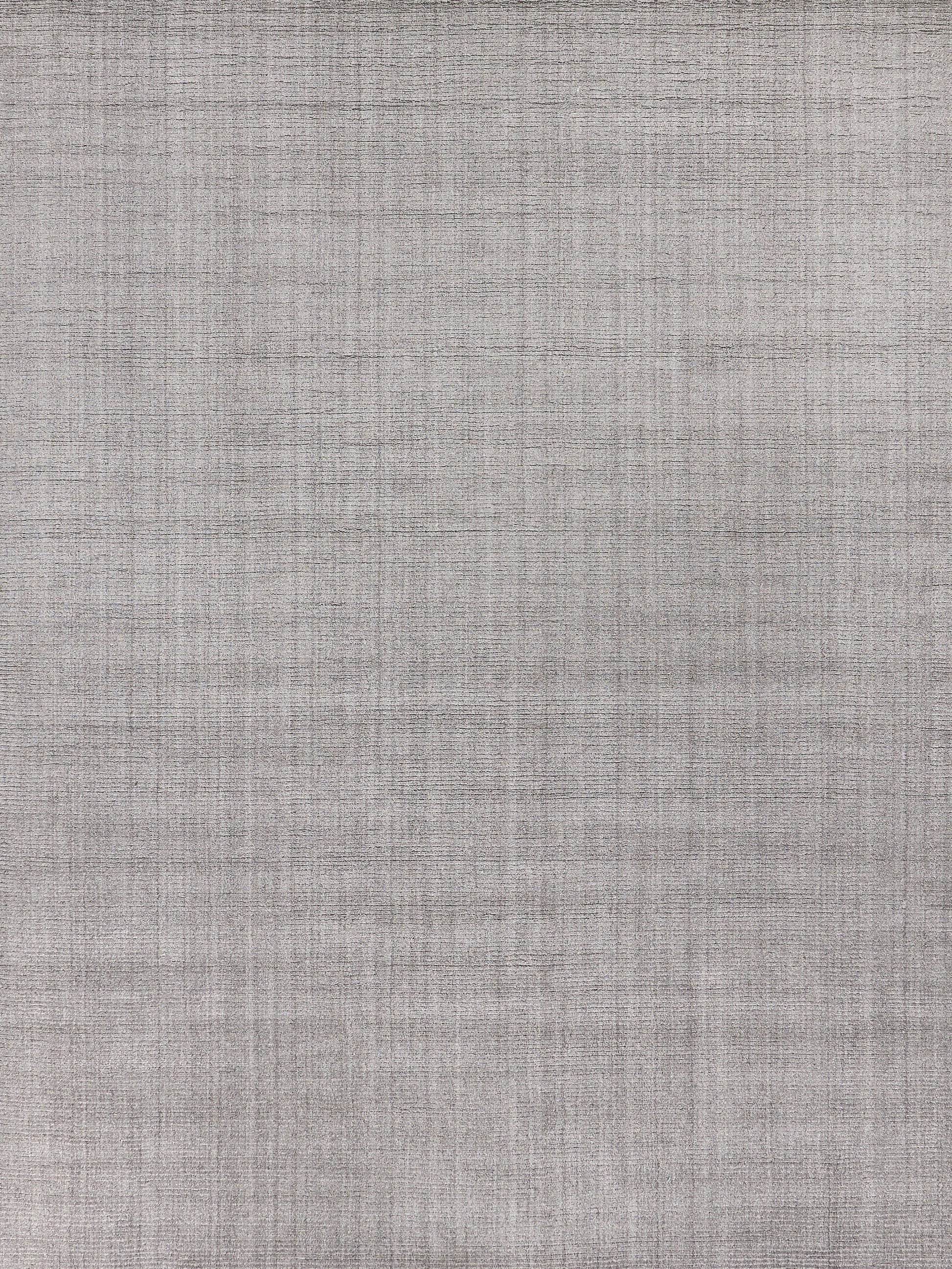 Grey linen-style rug with a subtle crosshatch texture, indoor hand-loomed, 6' x 9'.