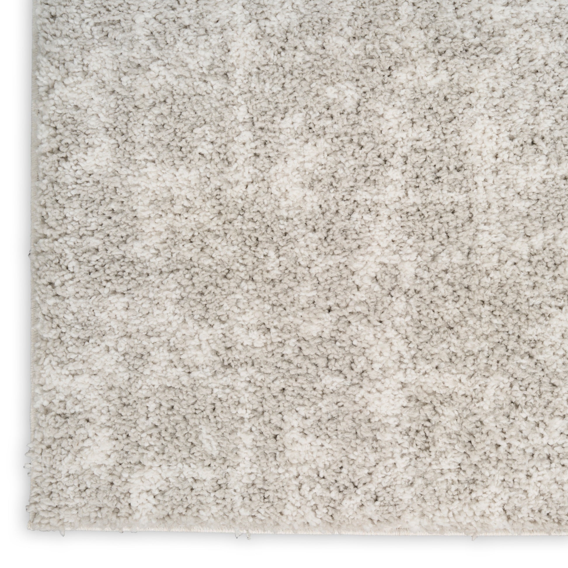 Cream shag rug with plush, high-pile texture; soft, cozy surface for living room or bedroom.