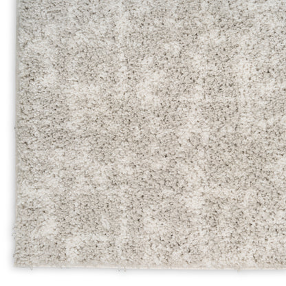 Cream shag rug close-up with plush high-pile fibers and soft, cozy texture; rectangular shape.