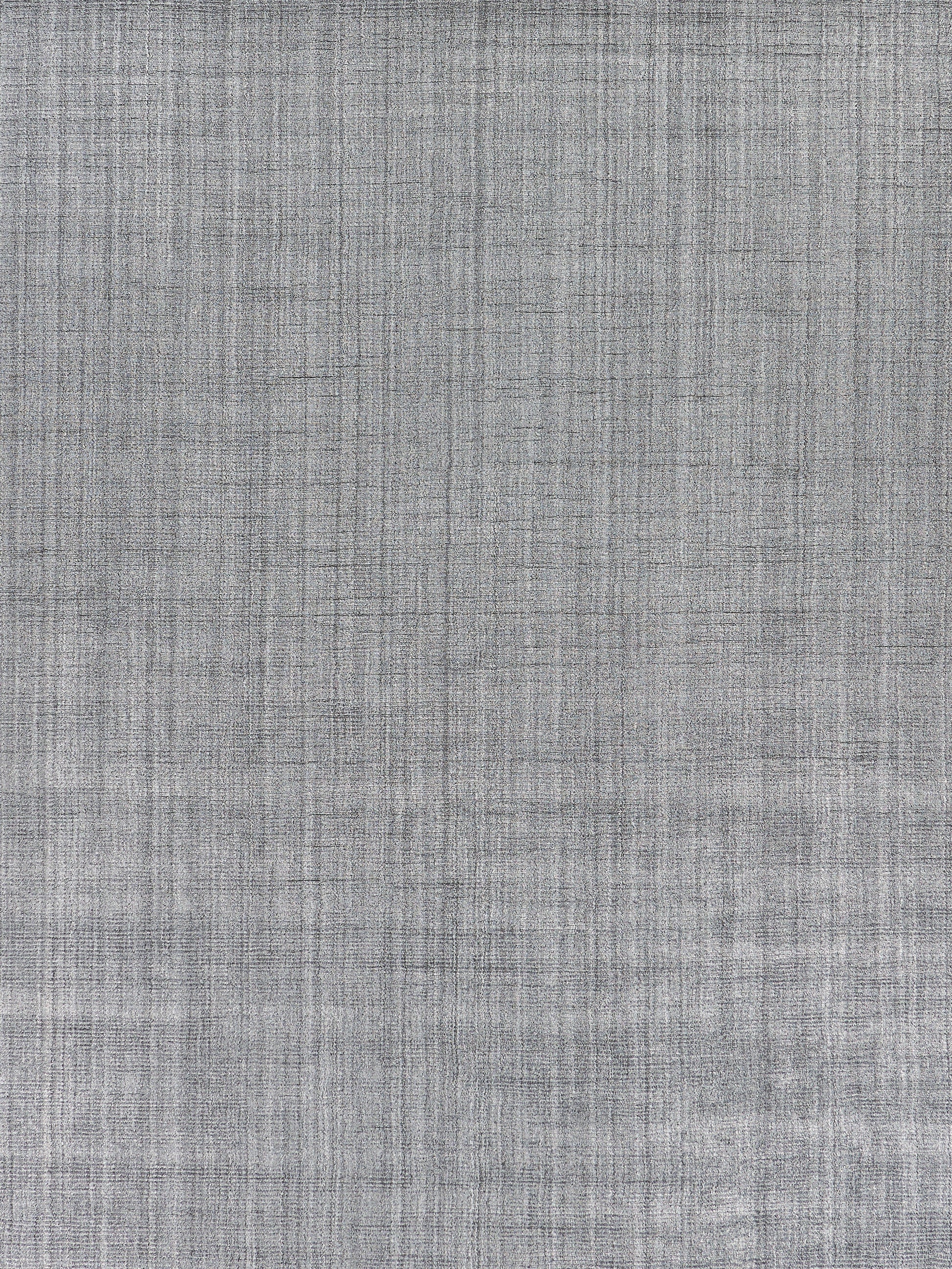 Grey hand-loomed indoor rug with a textured weave and subtle crosshatch pattern.