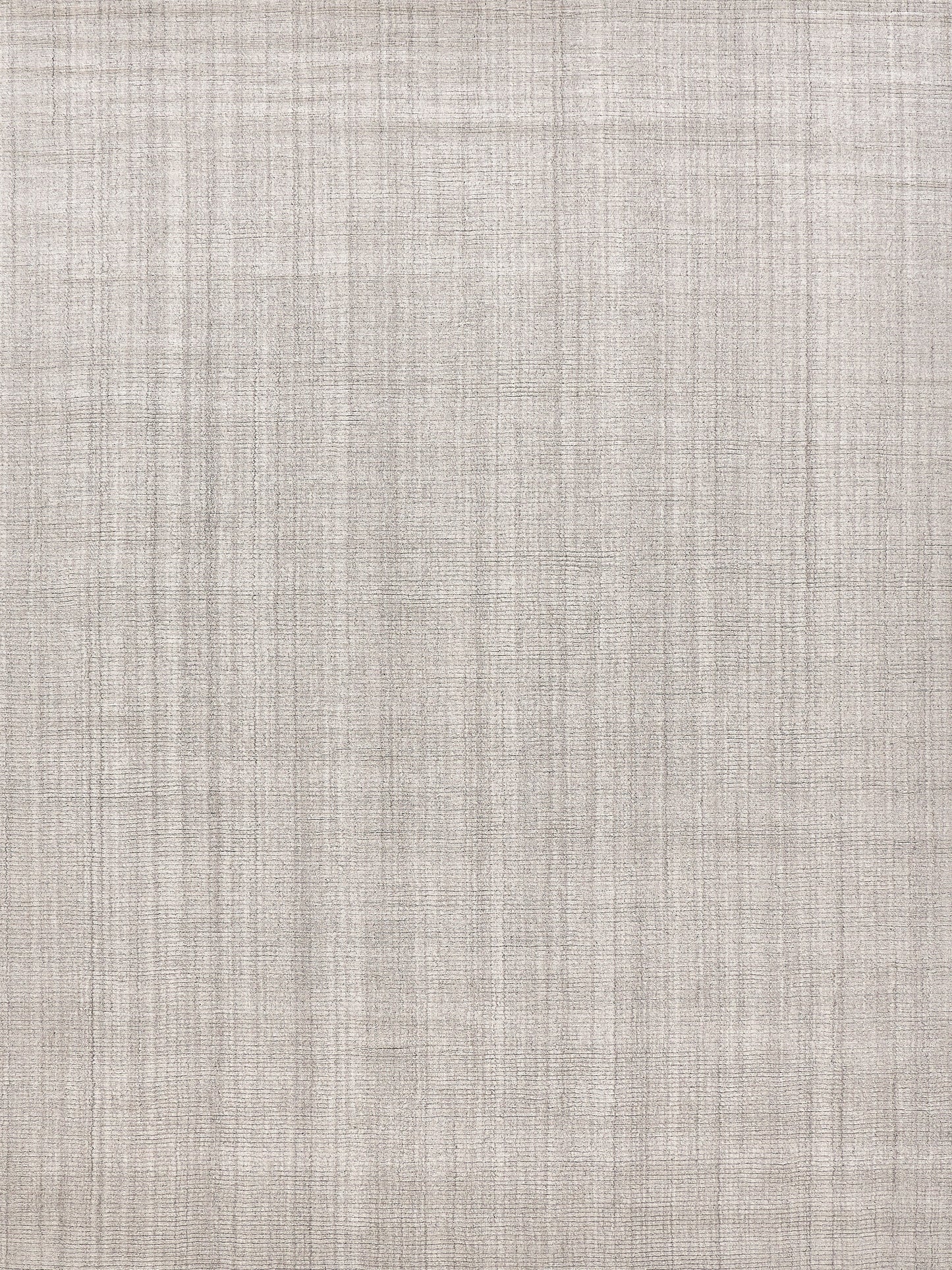 Beige hand-loomed indoor rug with a subtle crosshatch pattern.