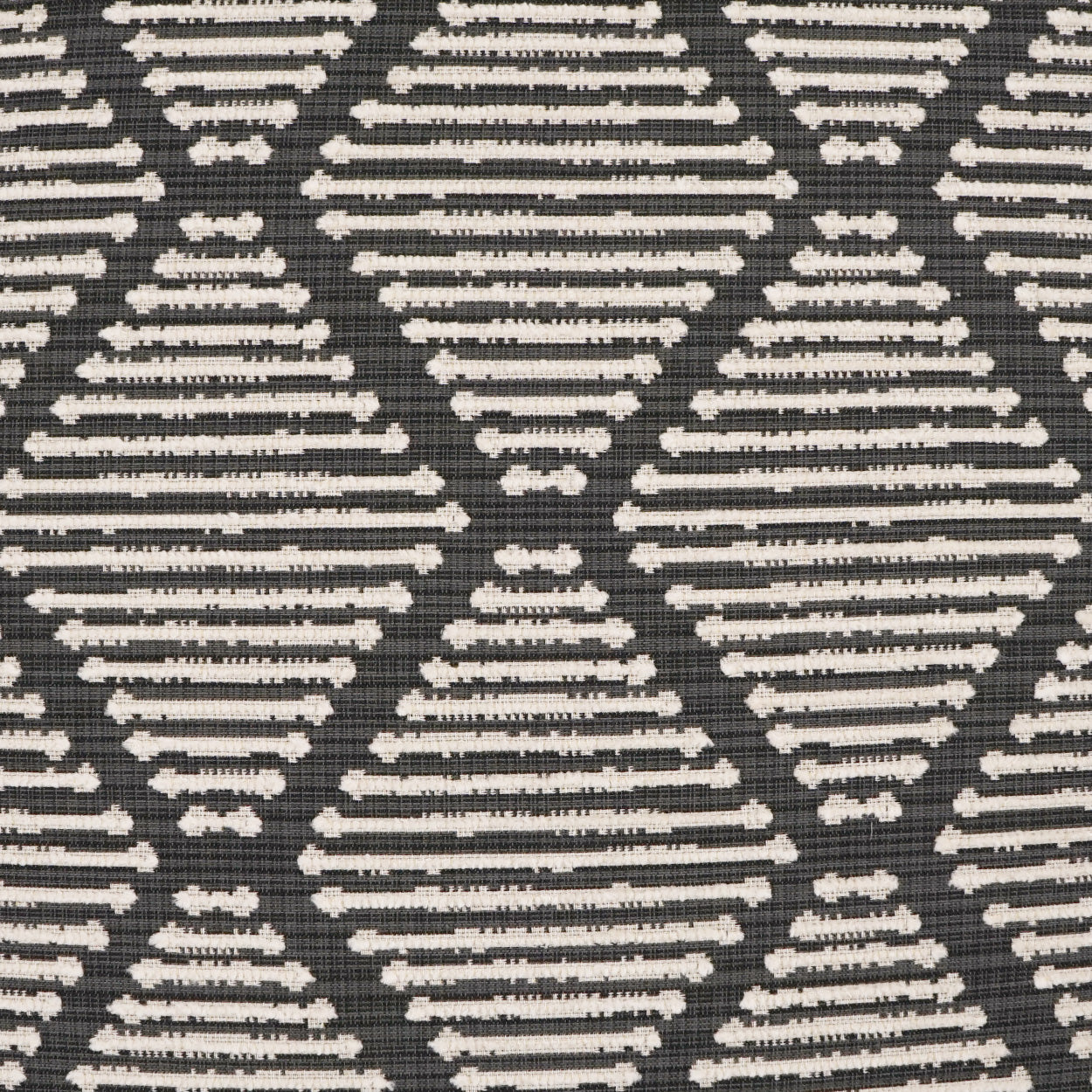Dark gray fabric with repeated white diamond shapes formed by stacked horizontal lines; geometric textile pattern.