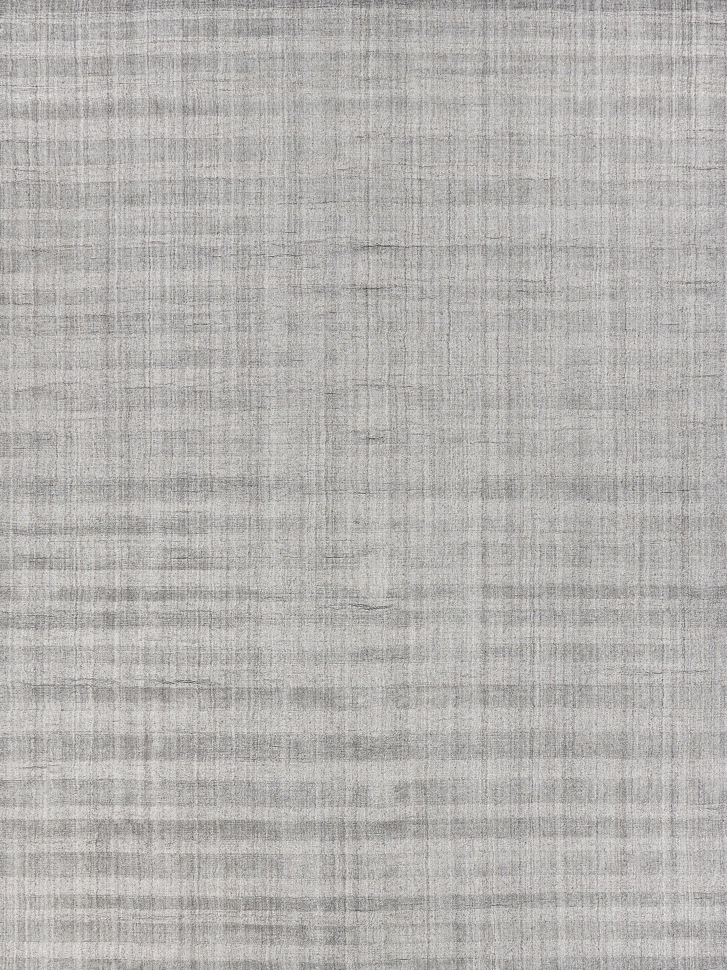 Light gray woven rug texture with subtle crosshatch pattern.