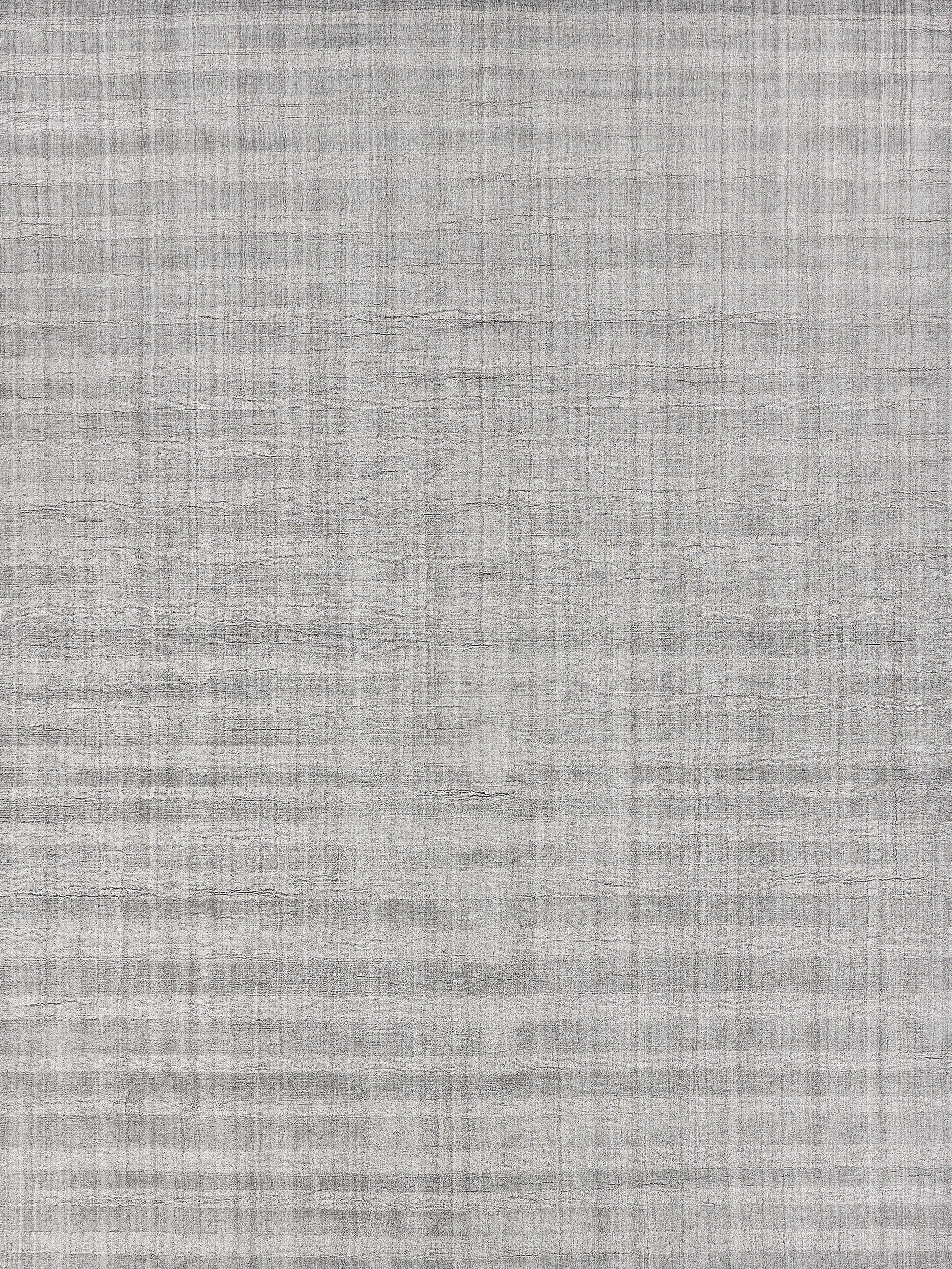 Light gray woven rug texture with subtle crosshatch pattern.