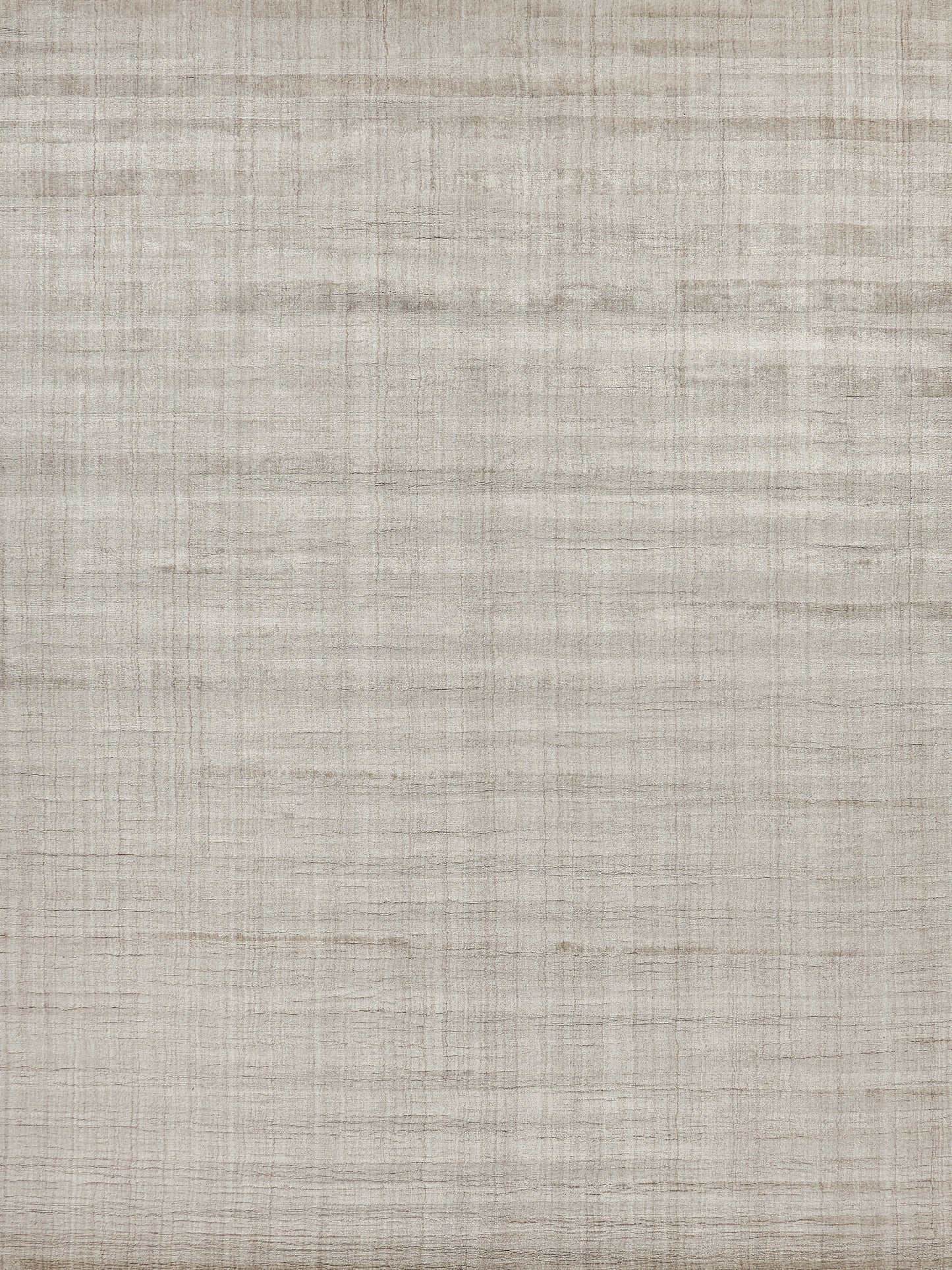Beige striped, indoor hand-loomed rug close-up showing woven fibers on a rustic background.
