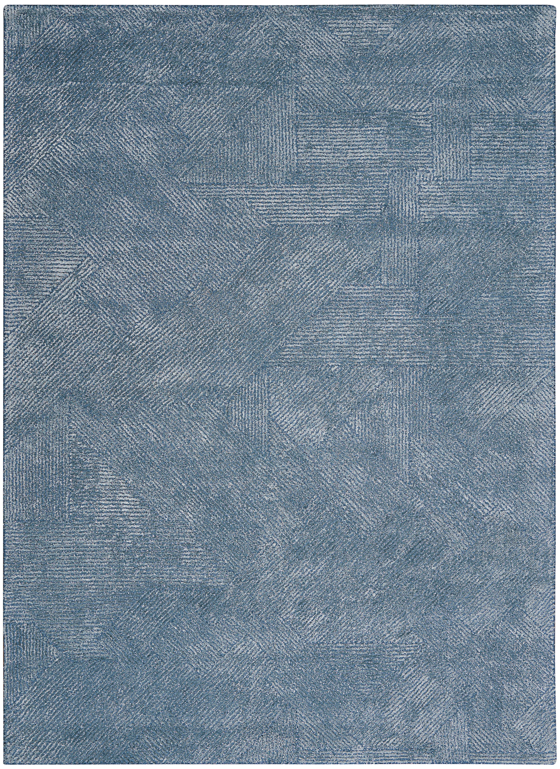 Rectangular blue rug with patchwork squares and brushed linear textures in denim tones.