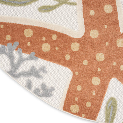 Partial view of an orange patterned rug with cream polka dots, curved white border sections, and gray-green leaf motifs.