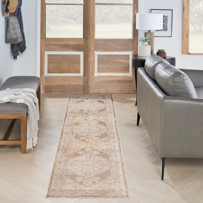 Beige oriental runner rug with a muted brown pattern on light wood floor in a modern living room.