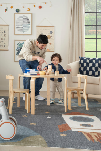 Natural wood kids table with two matching small chairs; minimalist, rounded edges, toddler-sized craft and snack set.