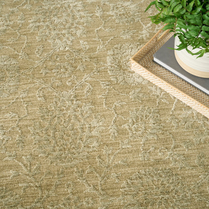 Beige textured area rug with a subtle cream floral pattern; top-right shows a woven rattan tray with a plant & books.