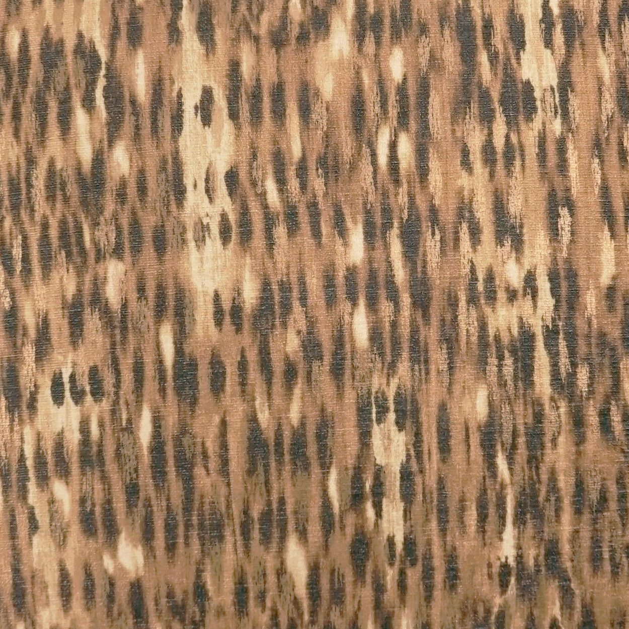 Leopard print fabric in tan, brown and black with irregular spots; textile pattern for clothing or home decor.