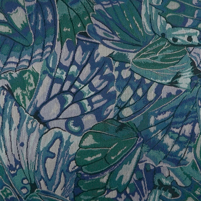 Teal and navy abstract pillow with a bold botanical-inspired pattern.