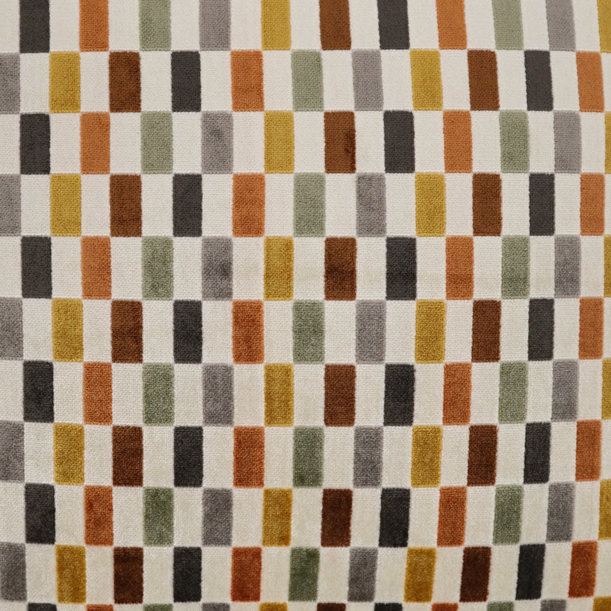 Woven fabric with a multicolor vertical-rectangle grid: orange, olive, gray, brown, black on beige; retro geometric pattern.