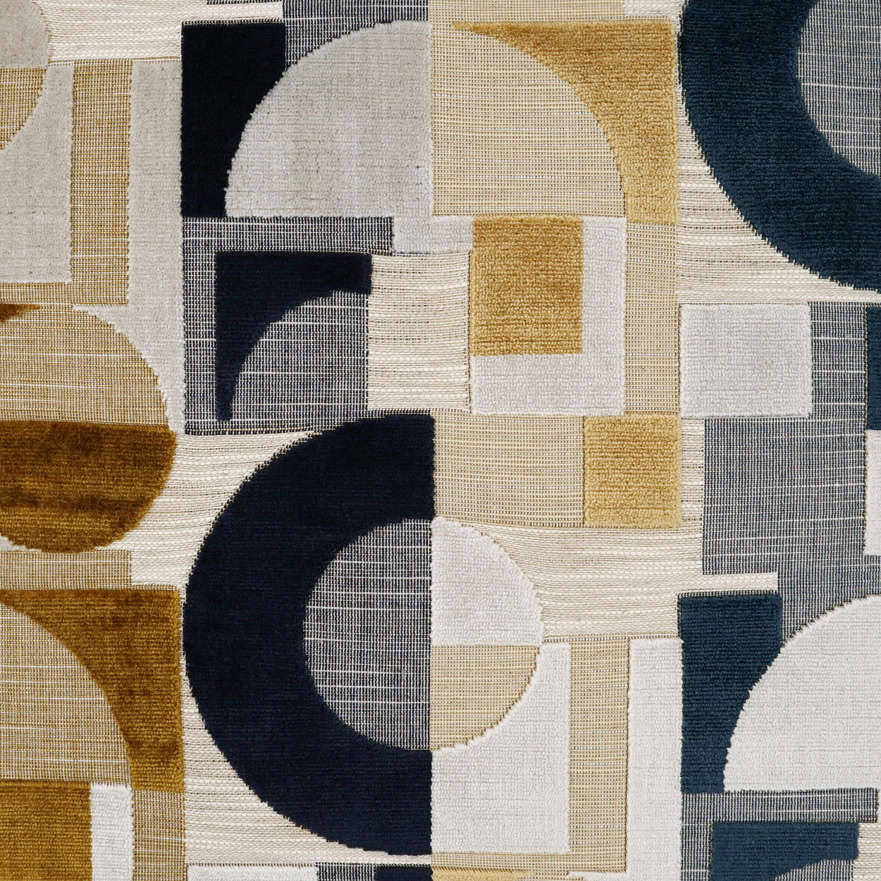 Geometric woven rug with squares, circles & arcs in navy, tan, beige, gray and white; modern abstract pattern.
