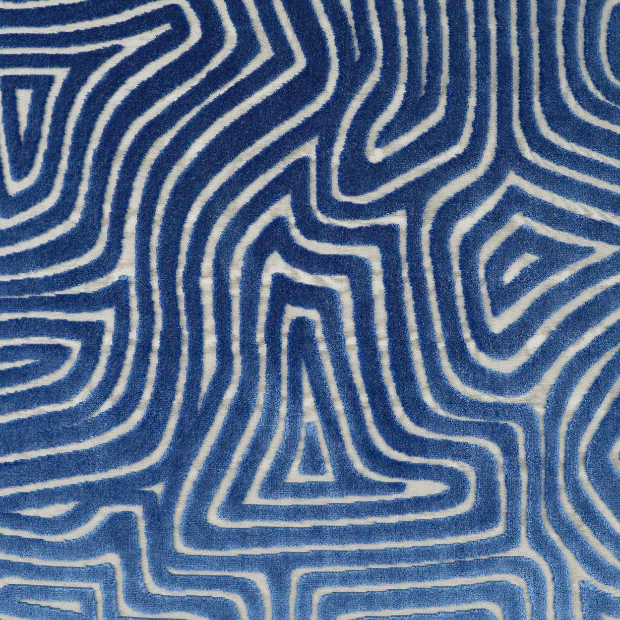 Blue and white fabric featuring a maze-like, wavy-line geometric pattern.